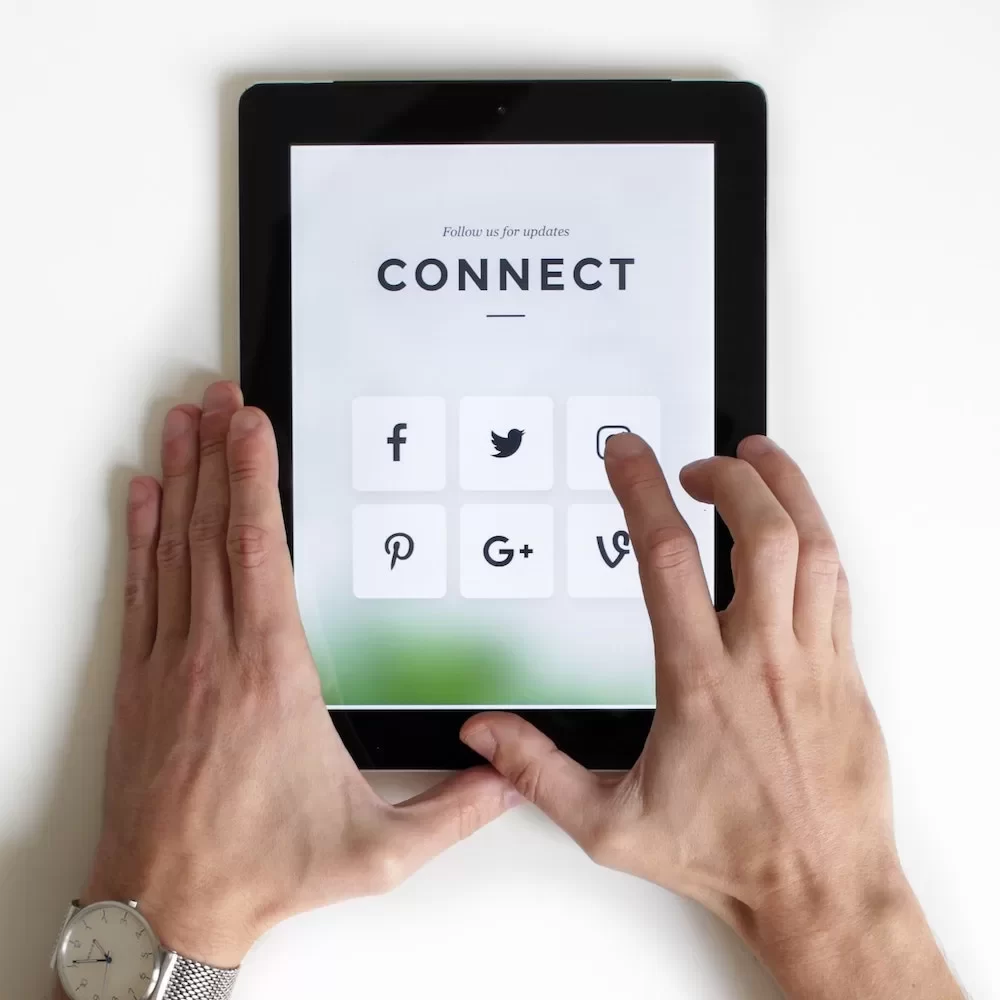 Hands holding an ipad showcasing connect services.